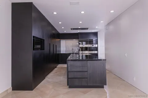 a kitchen with stainless steel appliances granite countertop a refrigerator and a stove
