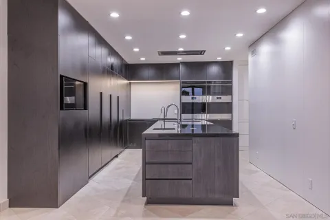 a kitchen with stainless steel appliances granite countertop a stove and a refrigerator