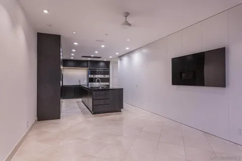a kitchen with kitchen island stainless steel appliances a sink cabinets and a counter top space