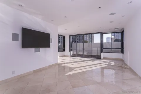 a view of an empty room with a window and a flat screen tv