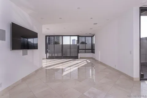 a spacious bedroom with a large window and a balcony
