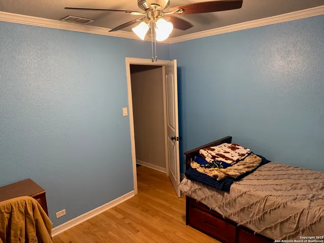 a bedroom with bed and a window