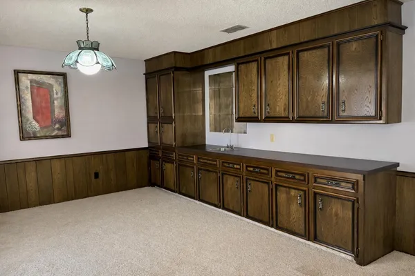 an empty room with windows and furniture