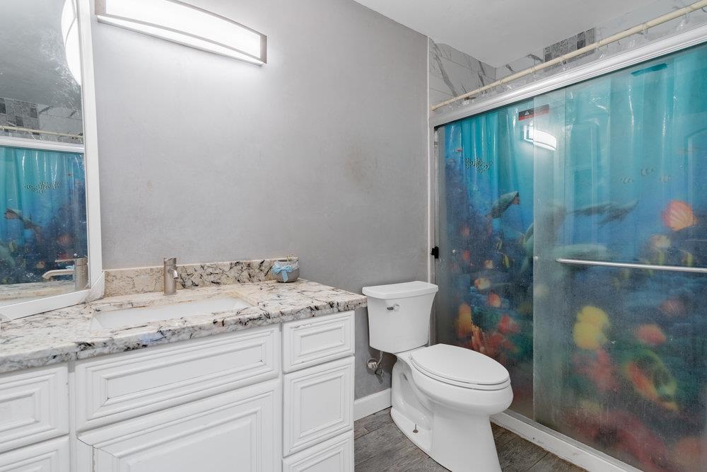 1793 Cherokee Drive, Unit 2 Salinas, CA 93906 - Photo 13 of 20 a bathroom with a granite countertop sink toilet and shower