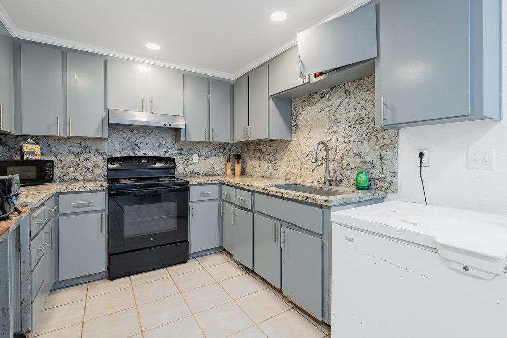 1793 Cherokee Drive, Unit 2 Salinas, CA 93906 - Photo 4 of 20 a kitchen with a sink dishwasher stove and white cabinets