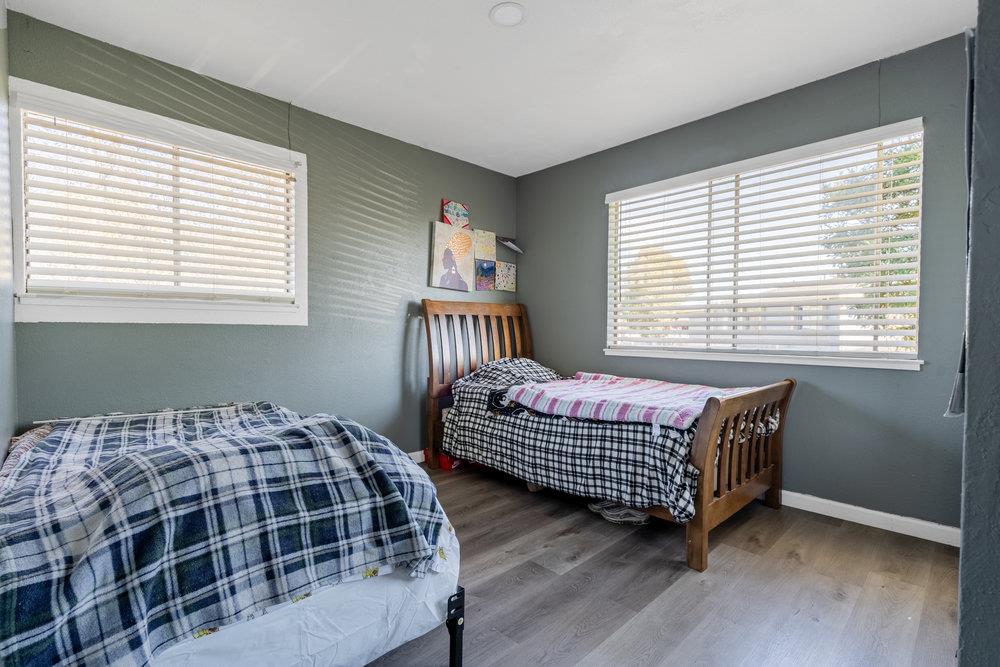 1793 Cherokee Drive, Unit 2 Salinas, CA 93906 - Photo 5 of 20 a bedroom with a bed next to a window and a chair