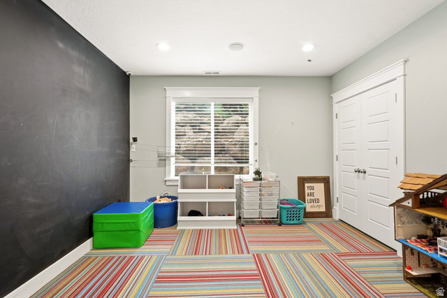672 Perry Hollow Drive Mapleton, UT 84664 - Photo 78 of 106 Play room featuring a full-wall chalkboard, colorful striped carpet, and recessed lighting