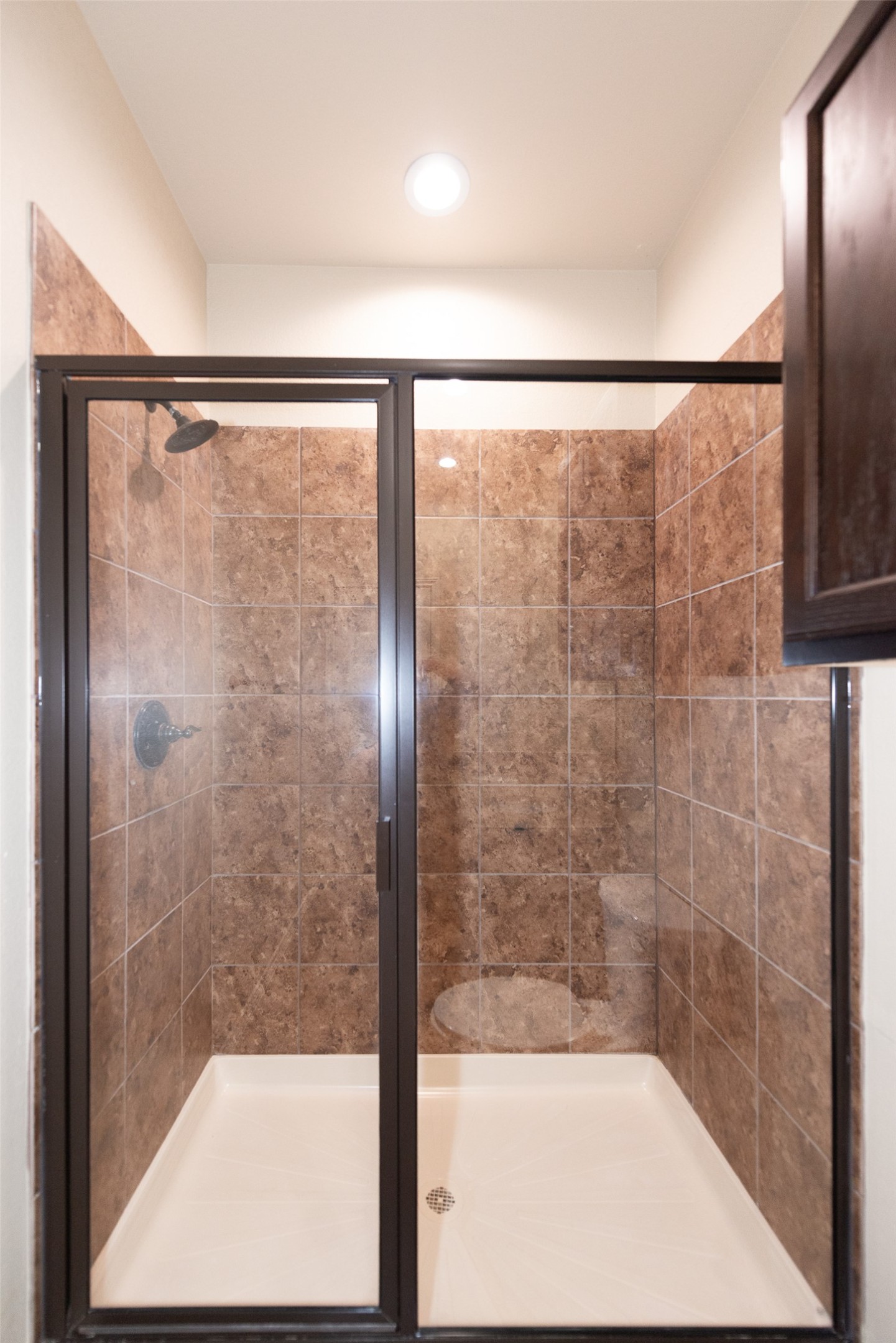 245 Joanne Loop, Unit B Buda, TX 78610 - Photo 27 of 33 Primary Bathroom, fully tiled shower, dual vanity, granite counters and recessed lighting