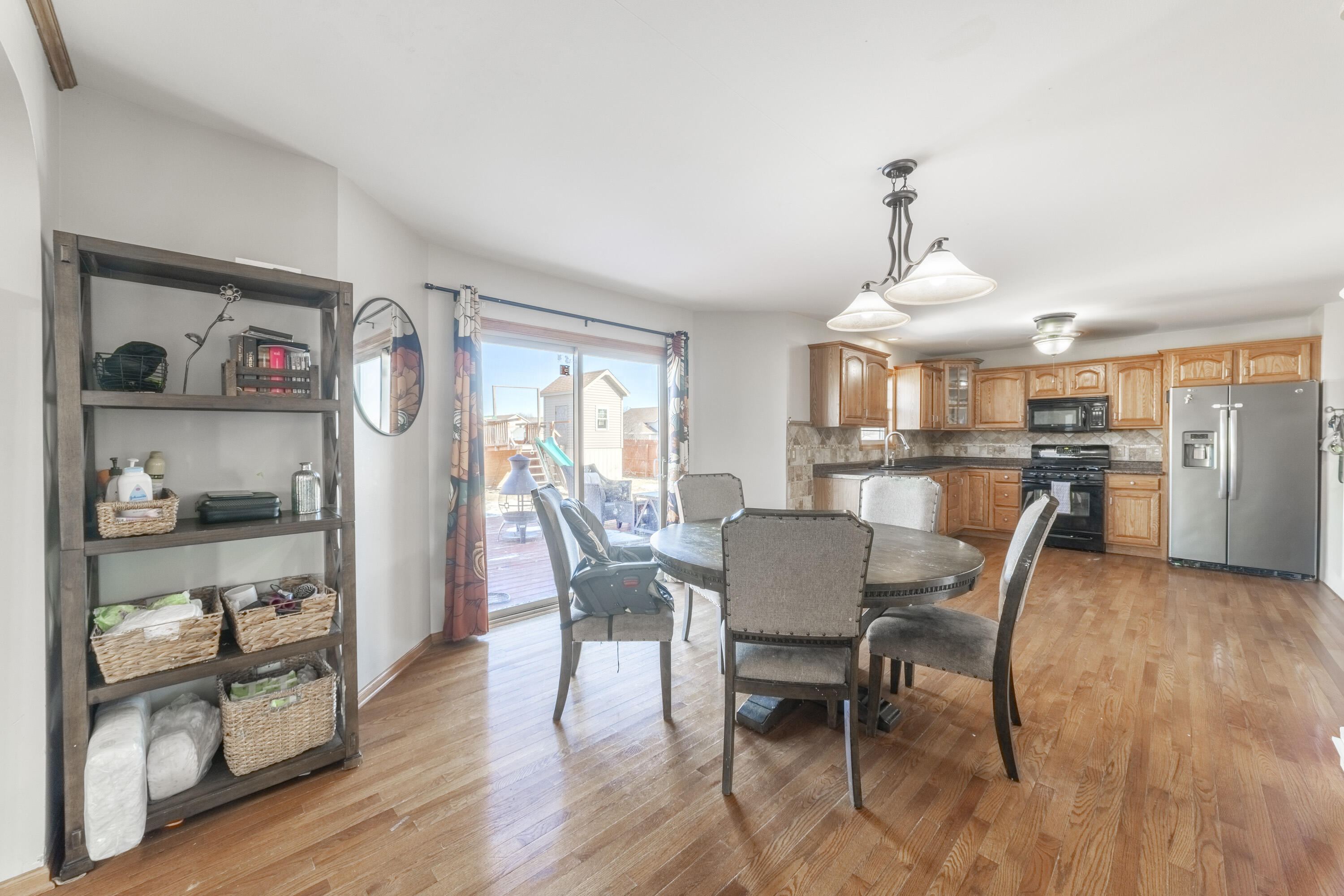 704 Coach Light Lane Lowell, IN 46356 - Photo 12 of 34 a view of a dining room with furniture and wooden floor