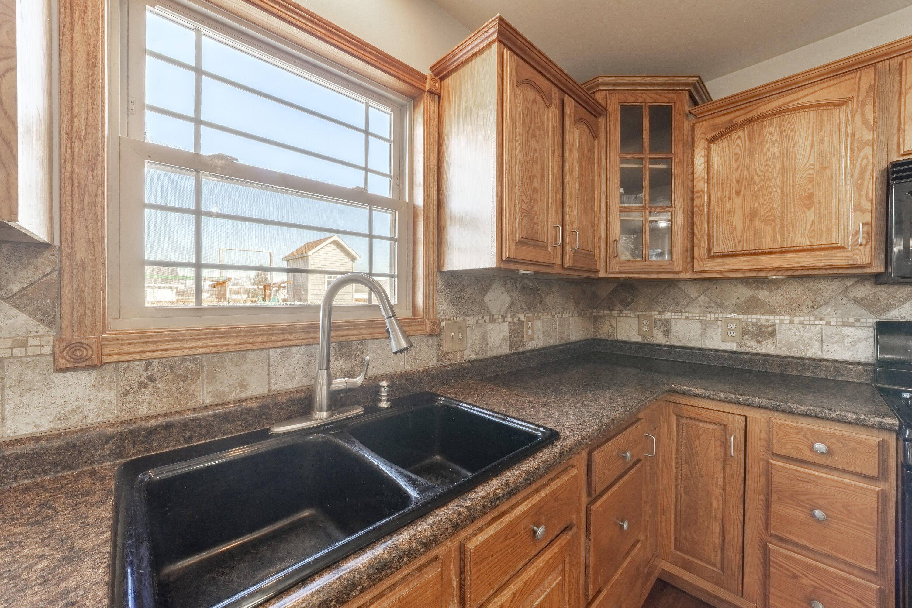 704 Coach Light Lane Lowell, IN 46356 - Photo 14 of 34 a kitchen with granite countertop a sink and a stove
