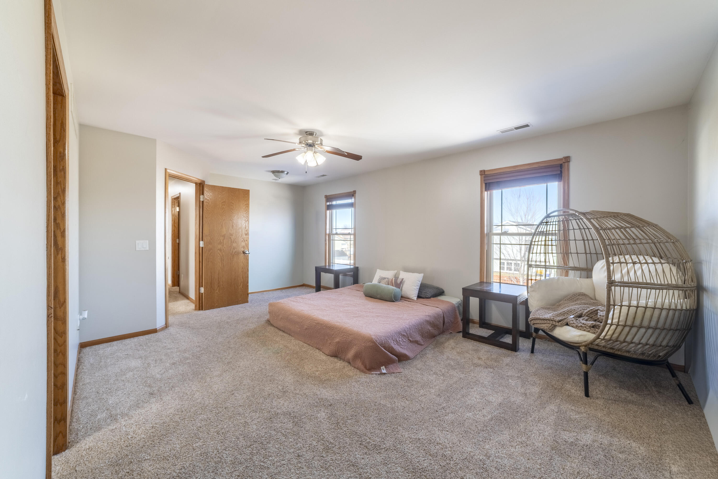 704 Coach Light Lane Lowell, IN 46356 - Photo 19 of 34 a spacious bedroom with a bed and a chandelier