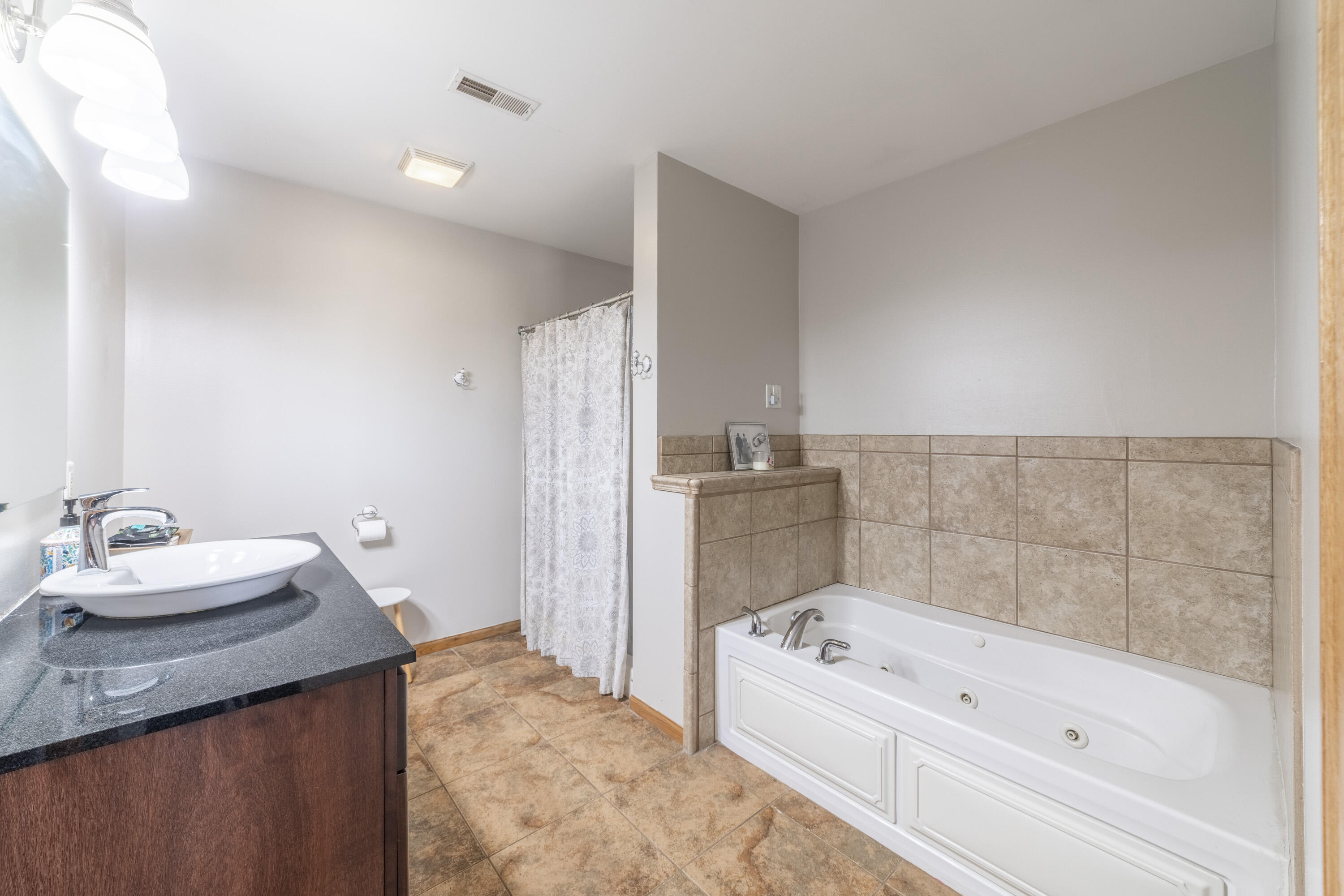 704 Coach Light Lane Lowell, IN 46356 - Photo 20 of 34 a bathroom with a bathtub and a sink