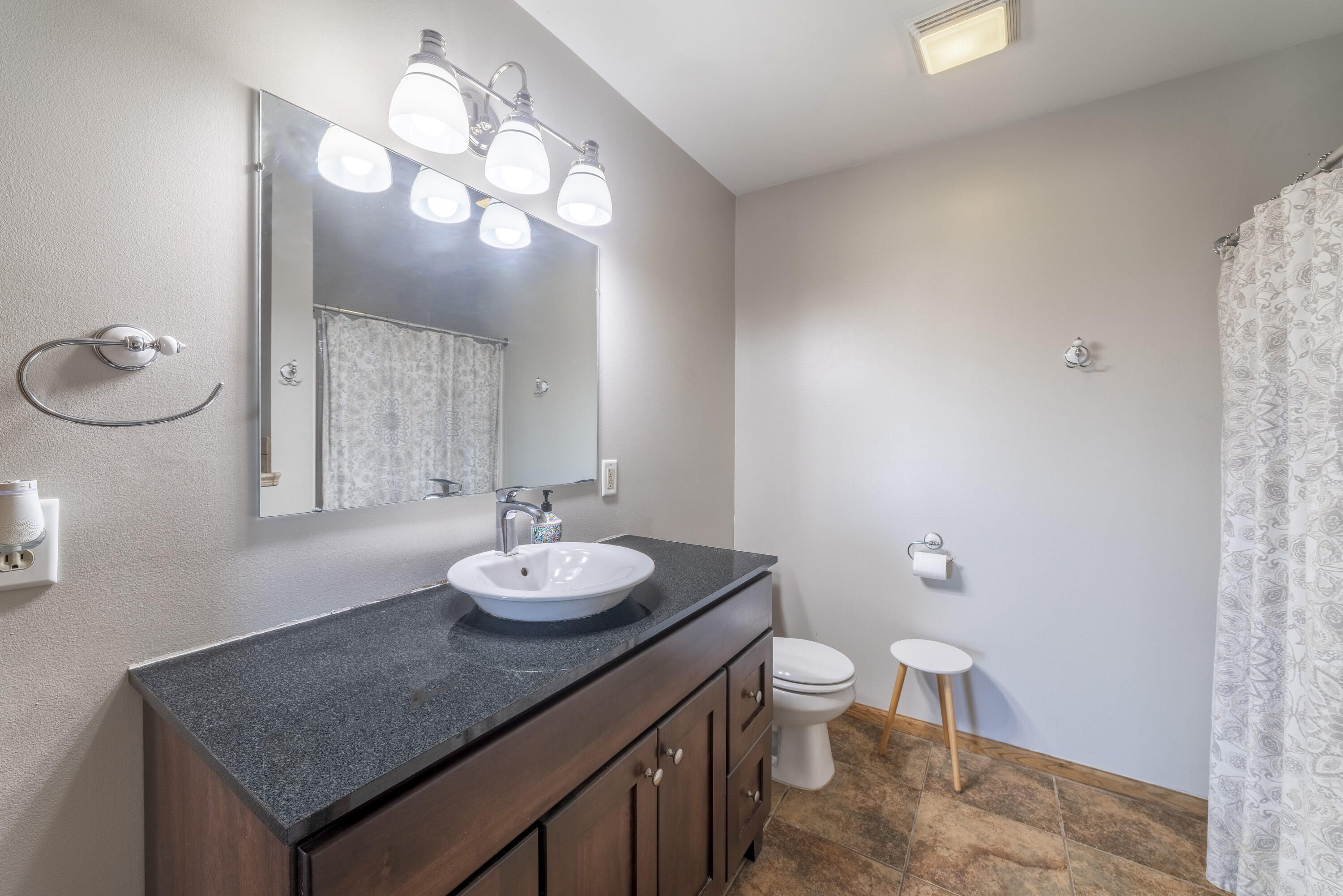 704 Coach Light Lane Lowell, IN 46356 - Photo 21 of 34 a bathroom with a sink a toilet and a mirror