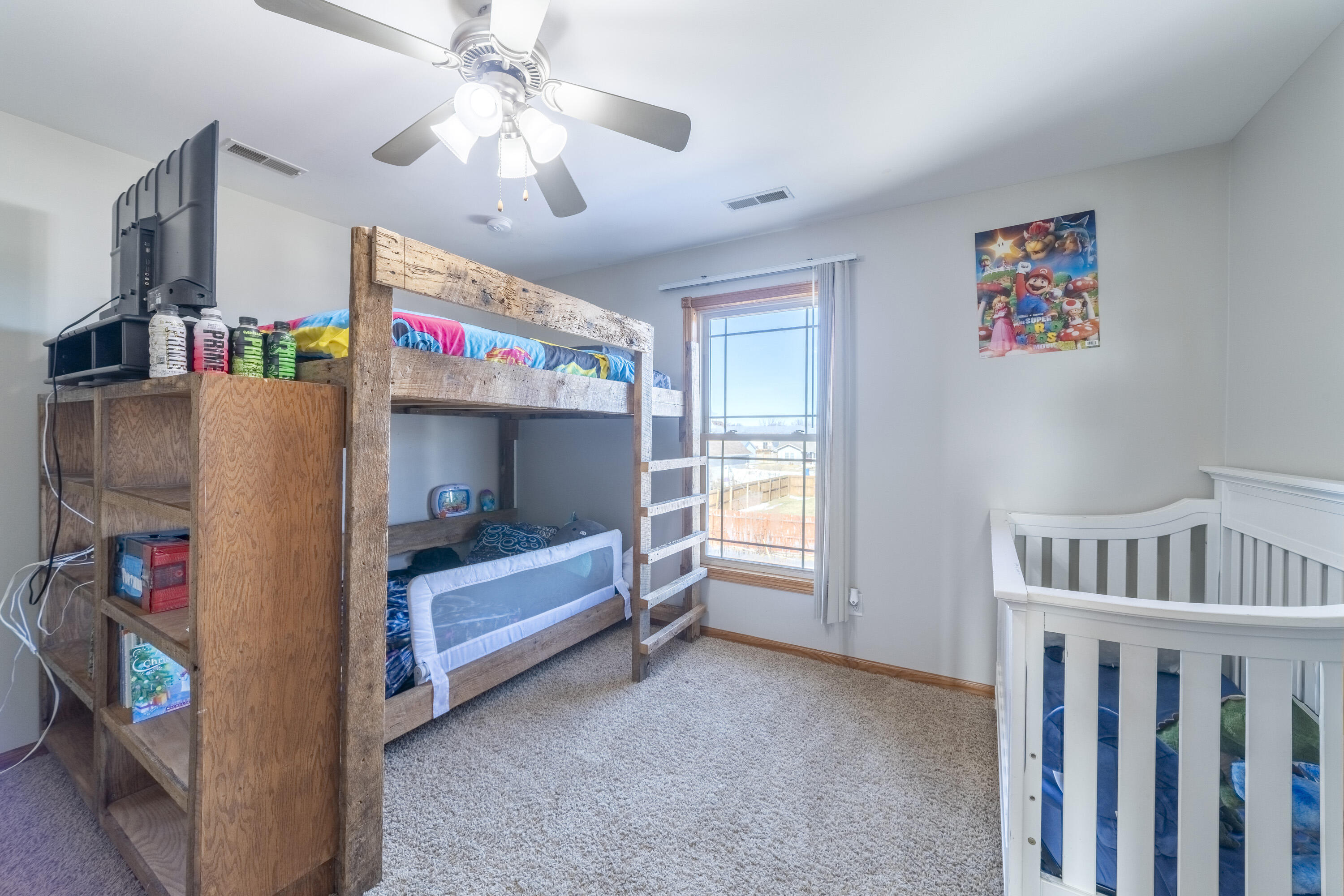 704 Coach Light Lane Lowell, IN 46356 - Photo 22 of 34 a living room with furniture and a baby crib