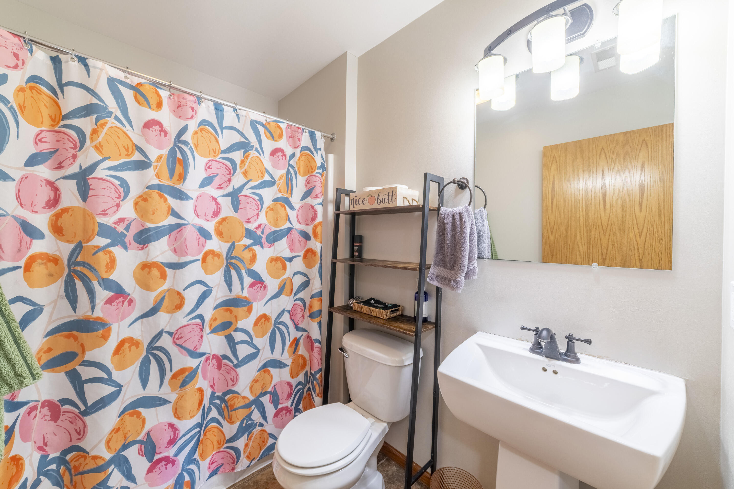 704 Coach Light Lane Lowell, IN 46356 - Photo 24 of 34 a bathroom with a sink and mirror with toilet