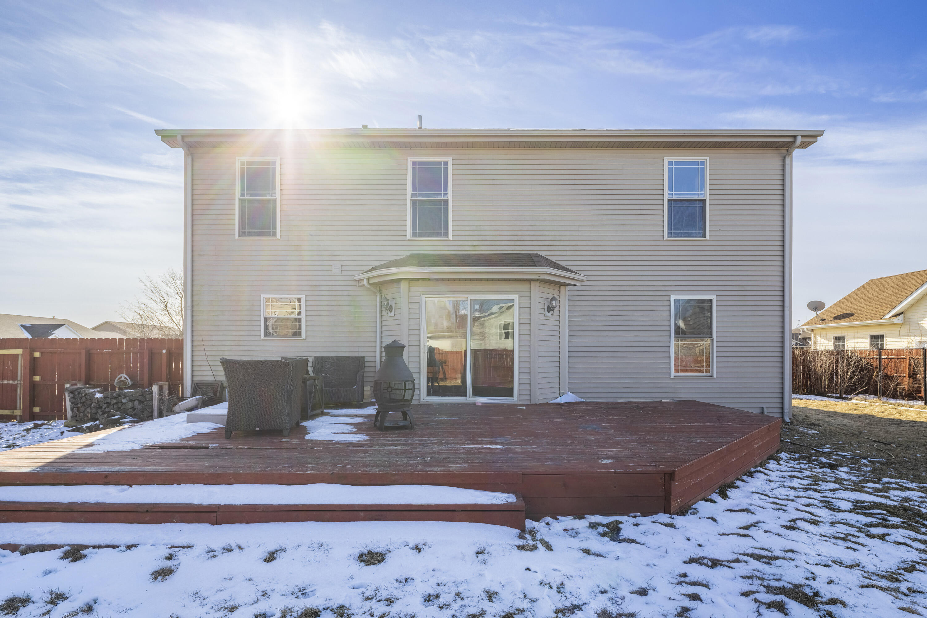 704 Coach Light Lane Lowell, IN 46356 - Photo 26 of 34 a view of a house with a floor to ceiling window and a yard