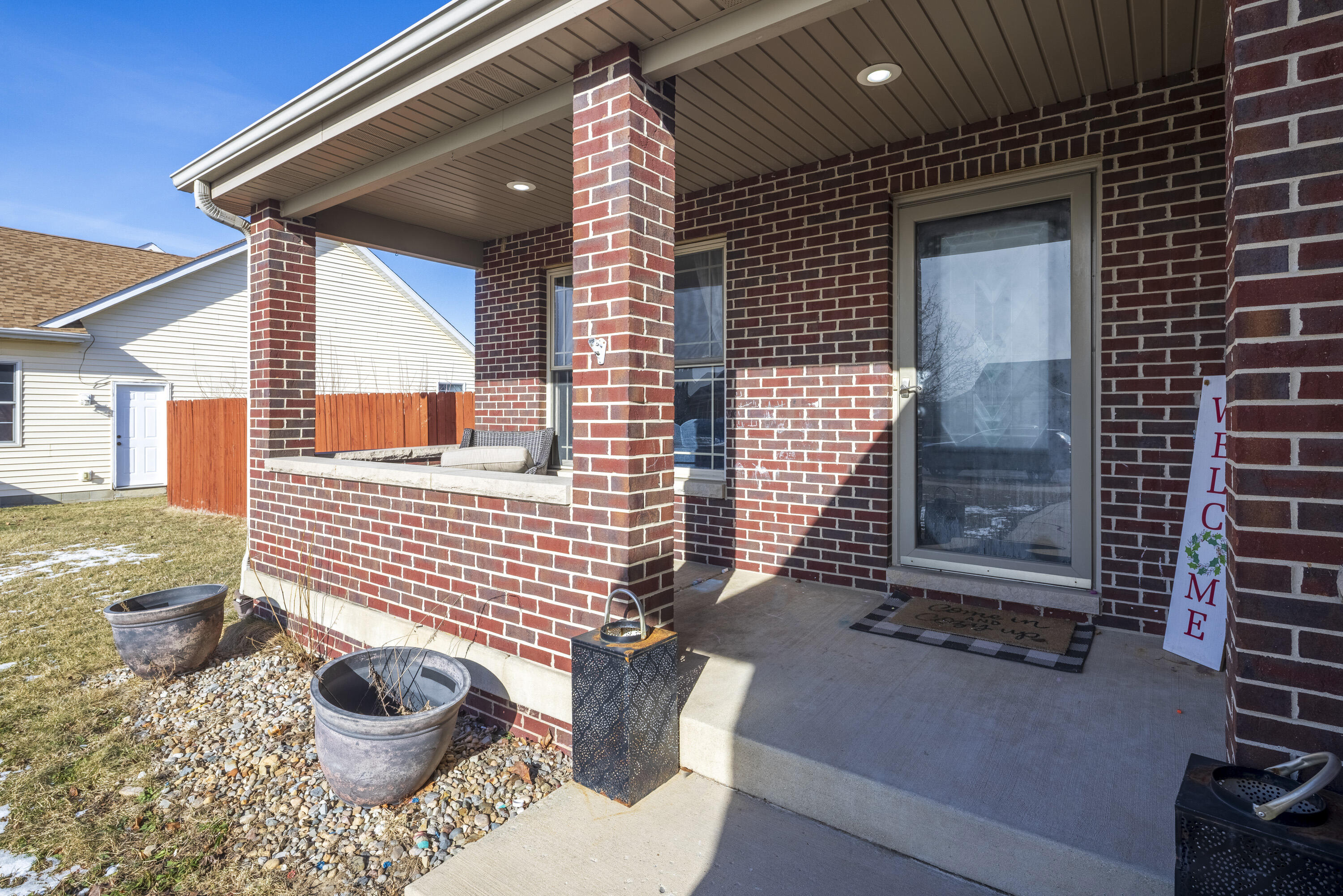 704 Coach Light Lane Lowell, IN 46356 - Photo 3 of 34 a view of a porch with a chair
