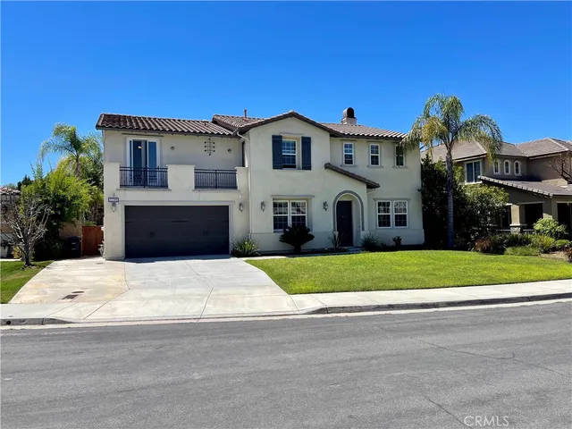 a front view of a house with a garden and plants