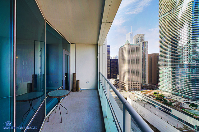 340 East Randolph Street, Unit 2402 Chicago, IL 60601 - Photo 12 of 26 a view of a balcony with furniture and a stove