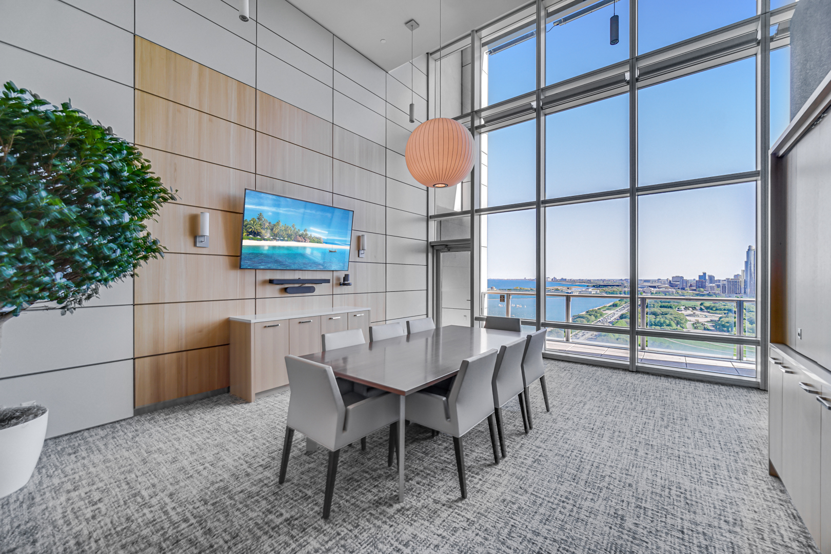 340 East Randolph Street, Unit 2402 Chicago, IL 60601 - Photo 18 of 26 a dining room with furniture and a floor to ceiling window
