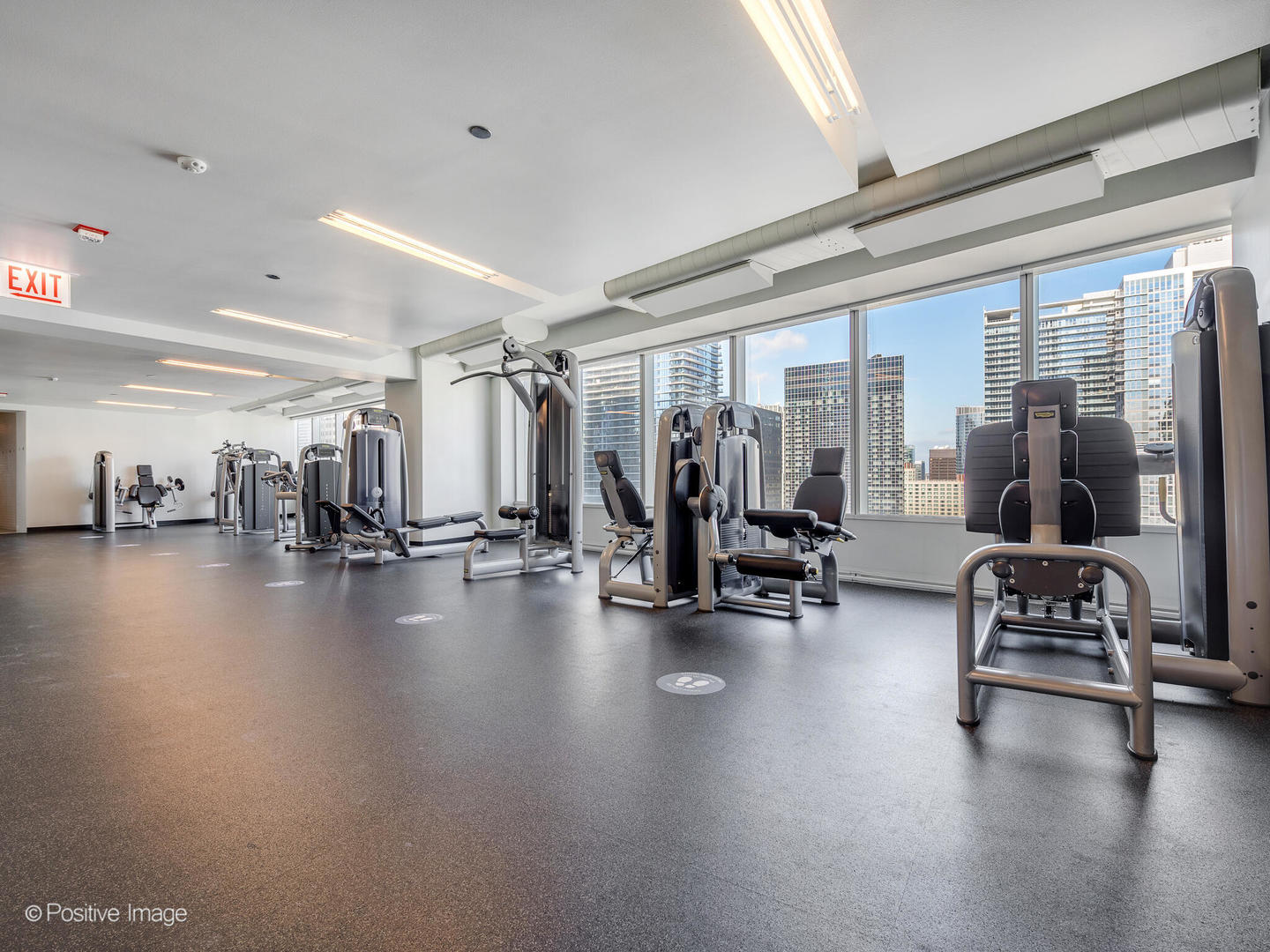 340 East Randolph Street, Unit 2402 Chicago, IL 60601 - Photo 19 of 26 a view of a room with gym equipment and a large window