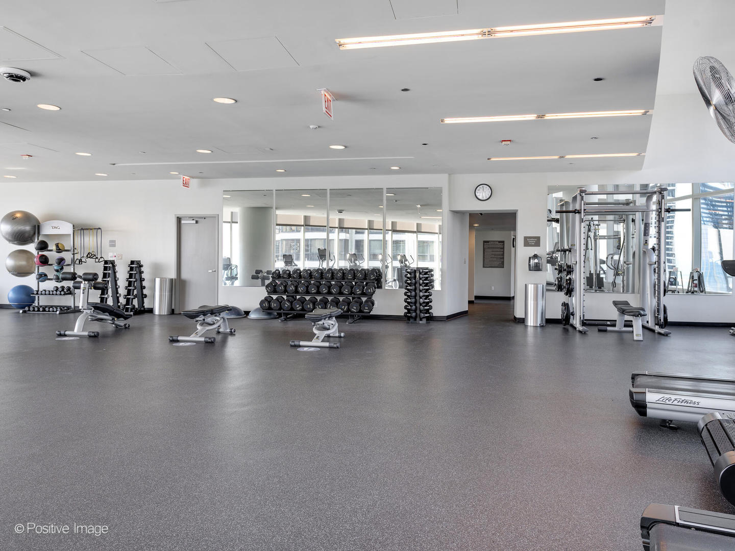 340 East Randolph Street, Unit 2402 Chicago, IL 60601 - Photo 21 of 26 a view of a room with gym equipment and large windows