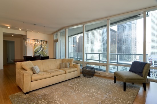 340 East Randolph Street, Unit 2402 Chicago, IL 60601 - Photo 3 of 26 a living room with furniture and a large window