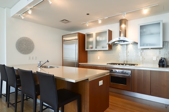 340 East Randolph Street, Unit 2402 Chicago, IL 60601 - Photo 5 of 26 a kitchen with stainless steel appliances granite countertop a stove a sink and a refrigerator