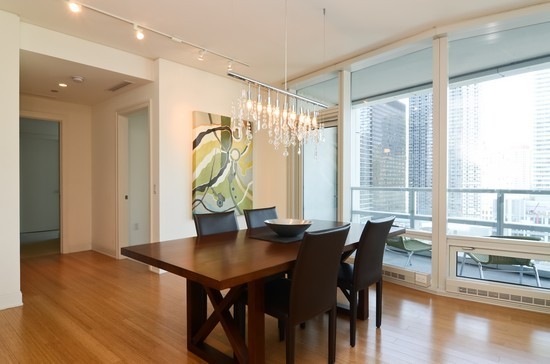 340 East Randolph Street, Unit 2402 Chicago, IL 60601 - Photo 6 of 26 a view of a dining room with furniture and wooden floor