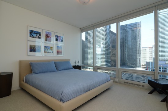 340 East Randolph Street, Unit 2402 Chicago, IL 60601 - Photo 7 of 26 a bedroom with a bed and a large window