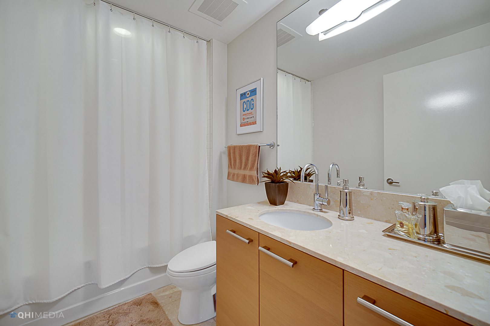 340 East Randolph Street, Unit 2402 Chicago, IL 60601 - Photo 10 of 26 a bathroom with a granite countertop sink and a toilet