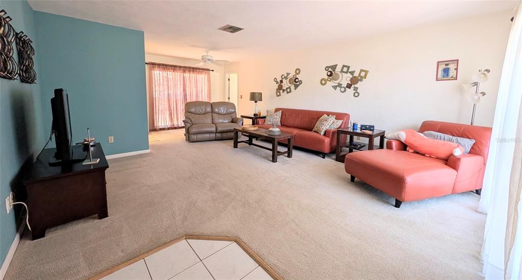 148 Serena Road DeBary, FL 32713 - Photo 4 of 25 a living room with furniture and a flat screen tv