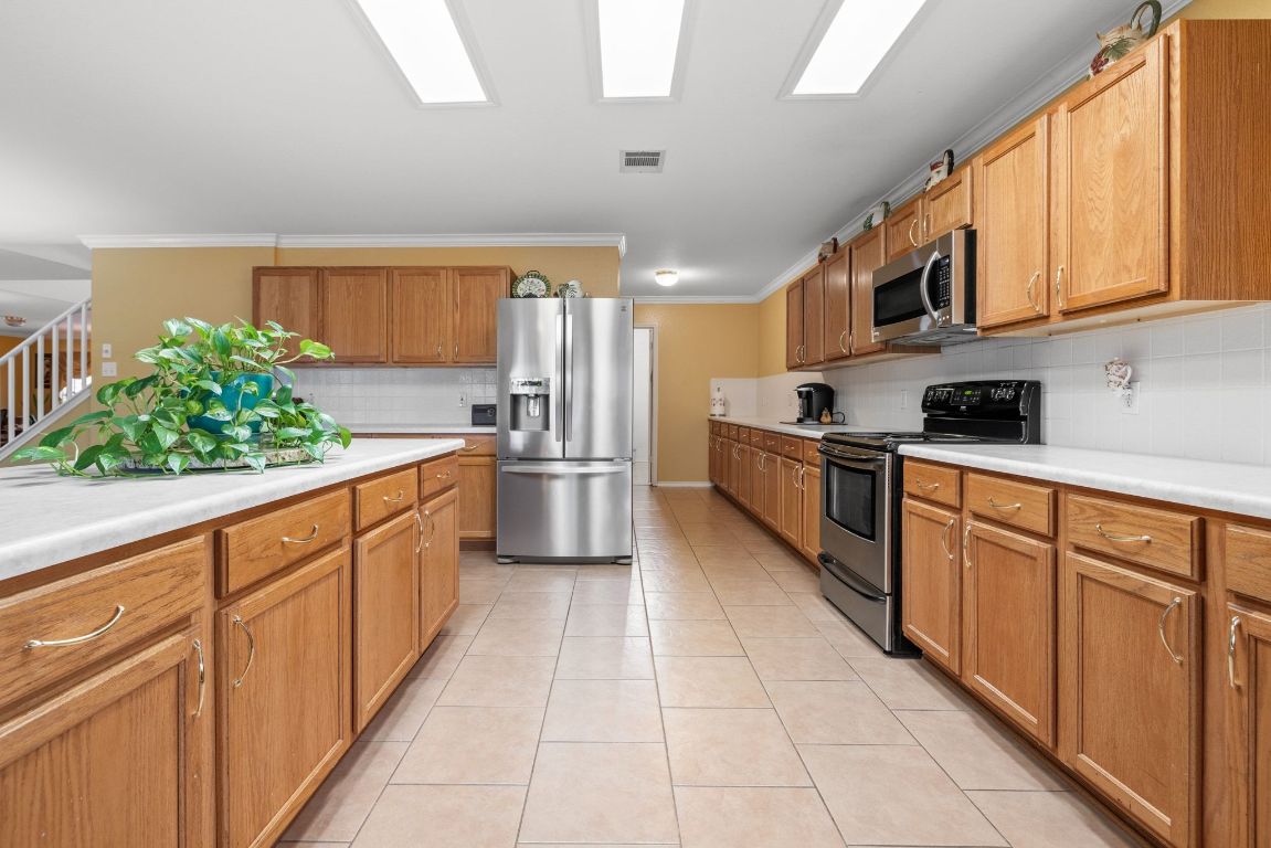 2210 Rachel Ridge Cedar Park, TX 78613 - Photo 17 of 40 a kitchen with stainless steel appliances granite countertop a refrigerator sink and cabinets