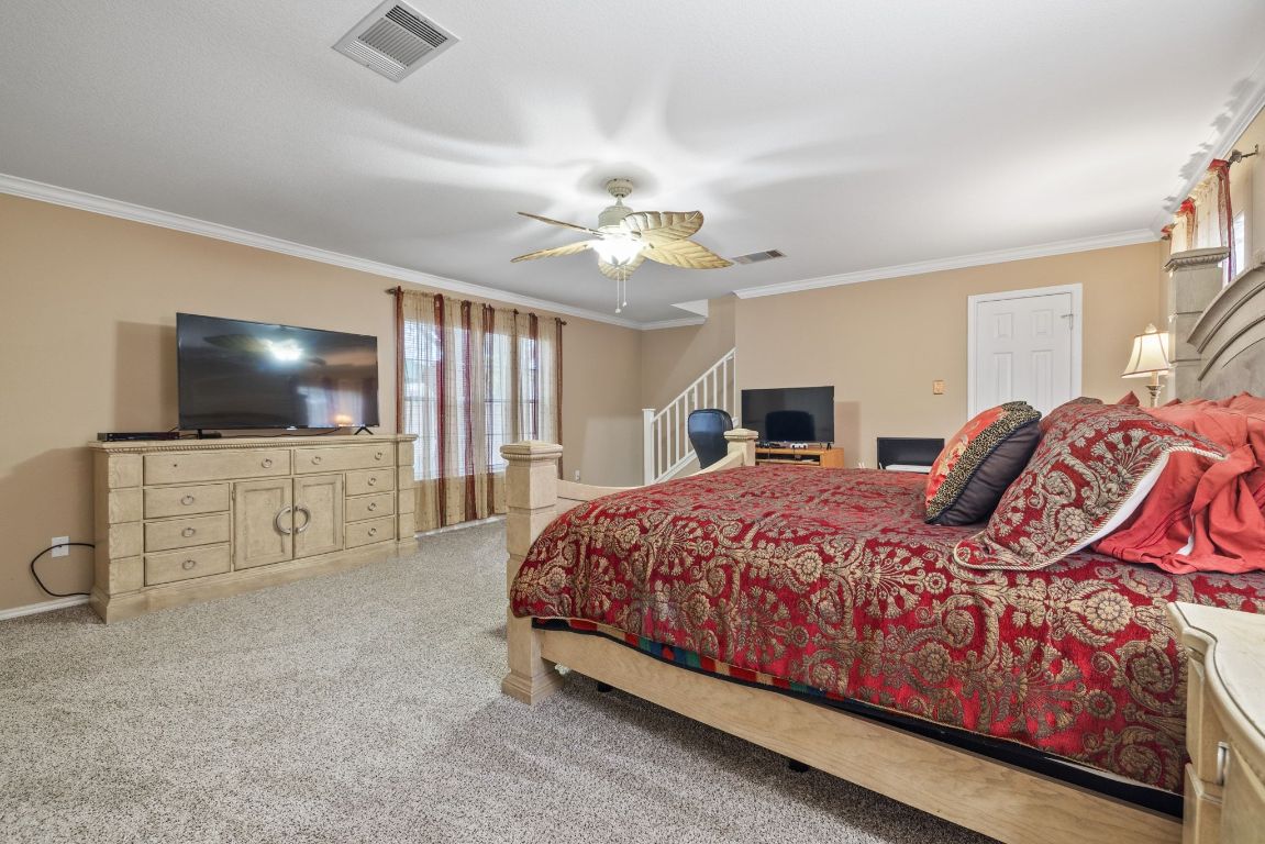 2210 Rachel Ridge Cedar Park, TX 78613 - Photo 20 of 40 a bedroom with a bed and a flat screen tv