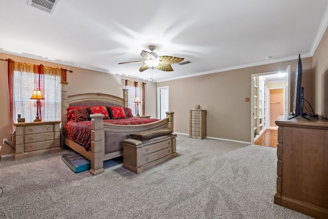 2210 Rachel Ridge Cedar Park, TX 78613 - Photo 21 of 40 a bedroom with a bed and a tv on the dresser