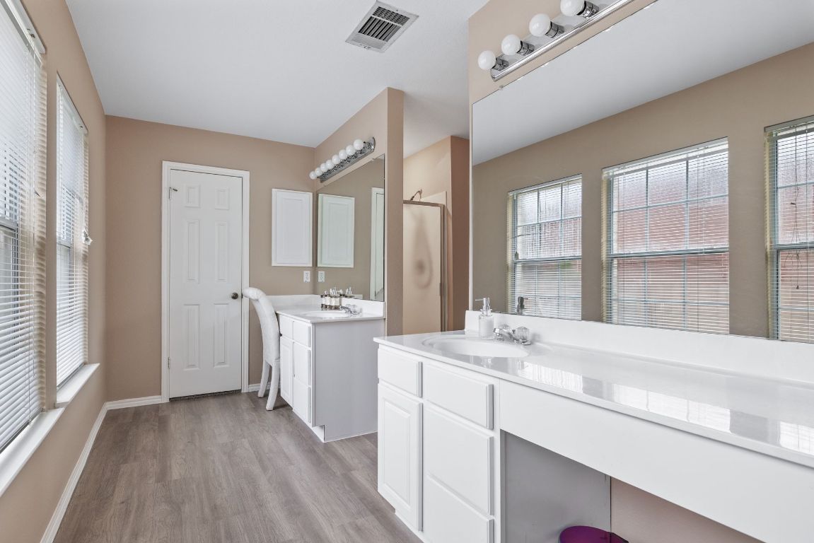 2210 Rachel Ridge Cedar Park, TX 78613 - Photo 24 of 40 a view of a sink and window with wooden floor