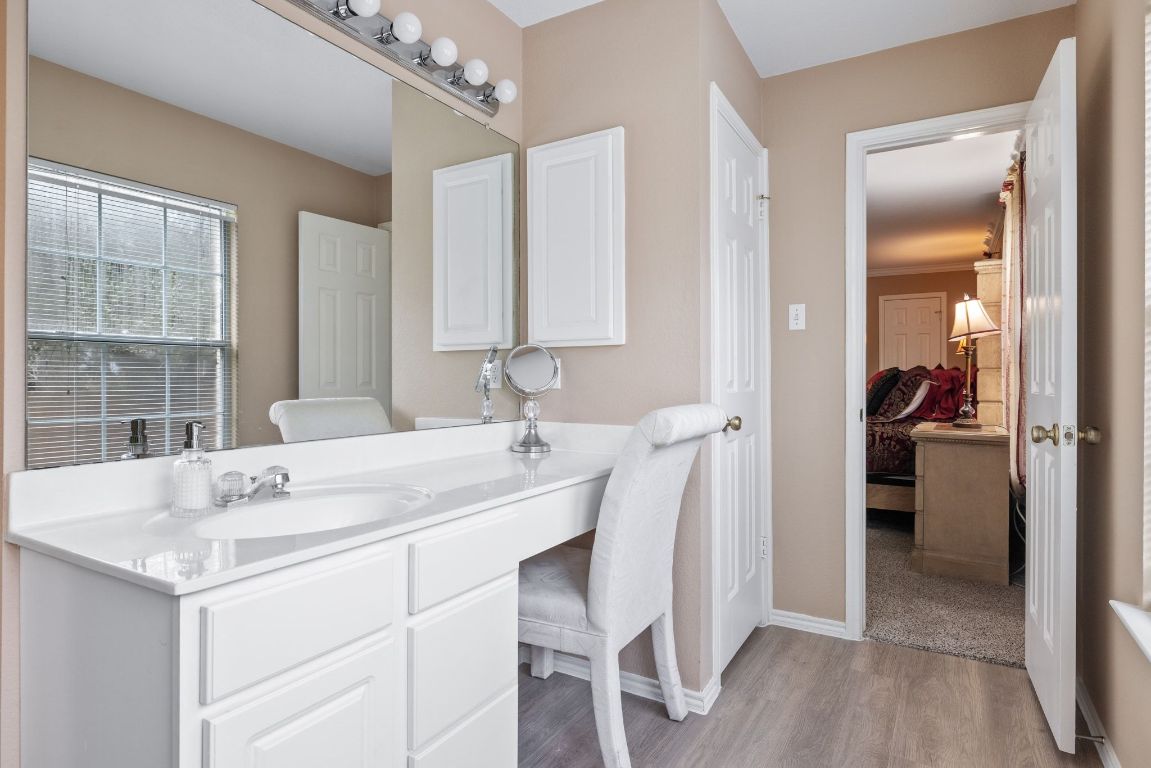 2210 Rachel Ridge Cedar Park, TX 78613 - Photo 25 of 40 a en suite bathroom with a granite countertop sink a mirror and a shower
