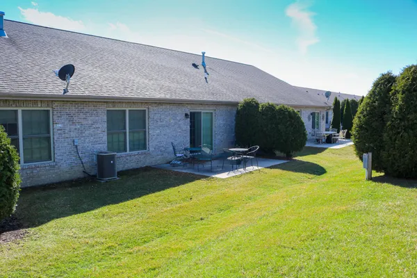 a view of a house with swimming pool and a yard