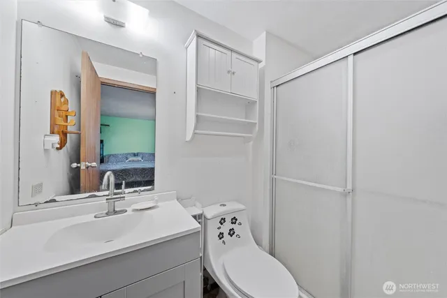 a bathroom with a sink toilet and shower