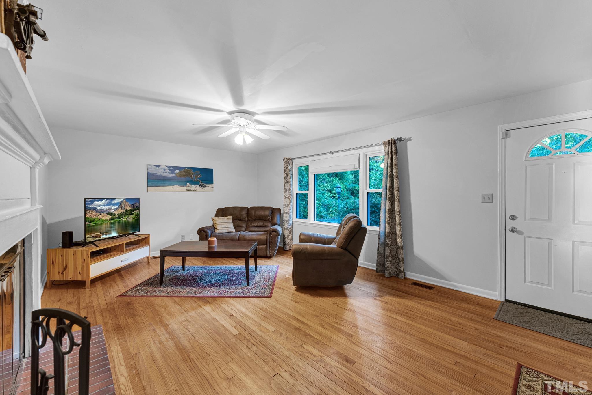 3422 Baugh Street Raleigh, NC 27604 - Photo 8 of 28 a living room with furniture and a wooden floor