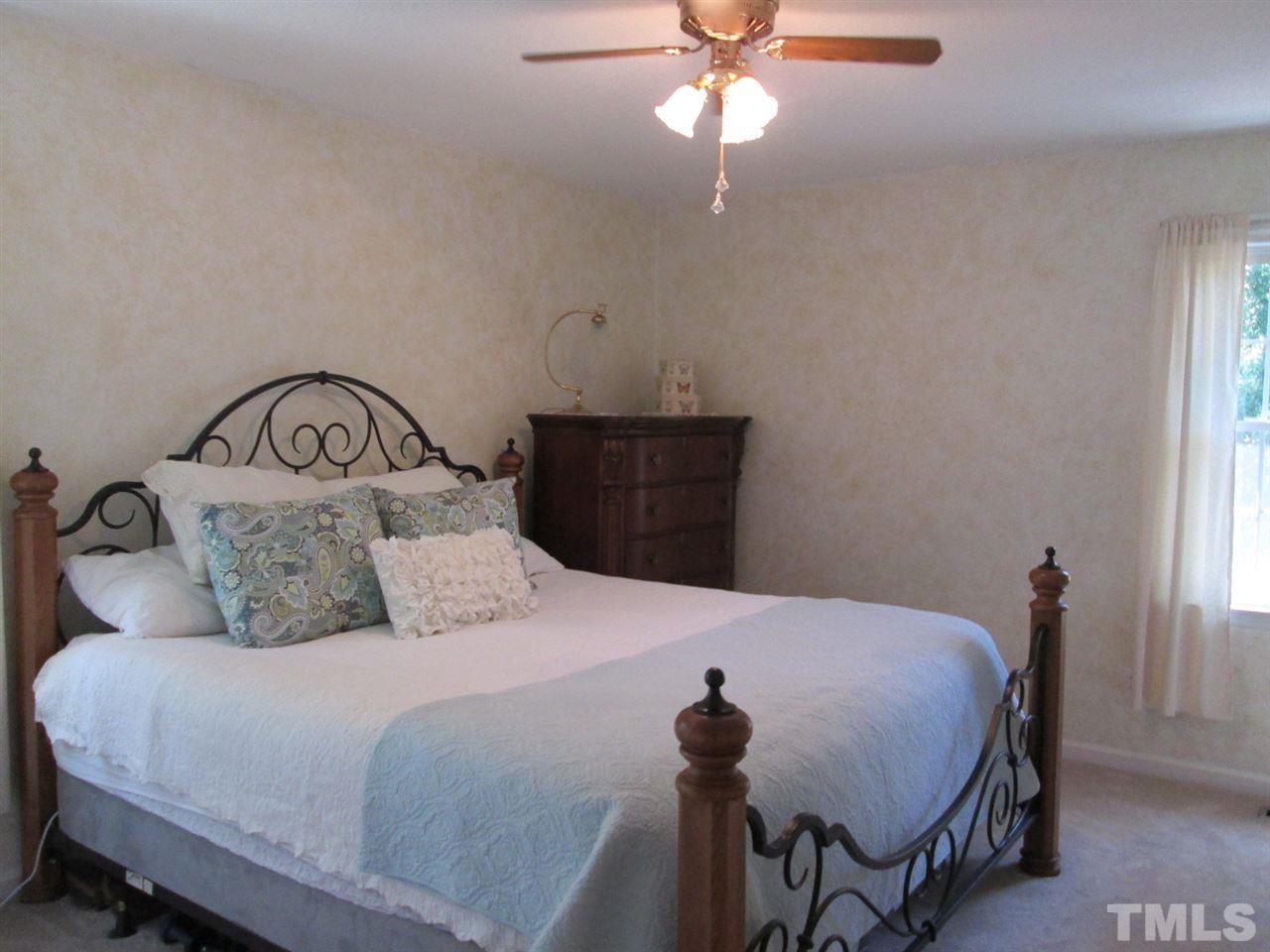 7001 Kiger Road Rougemont, NC 27572 - Photo 13 of 25 a bedroom with a bed and wooden floor