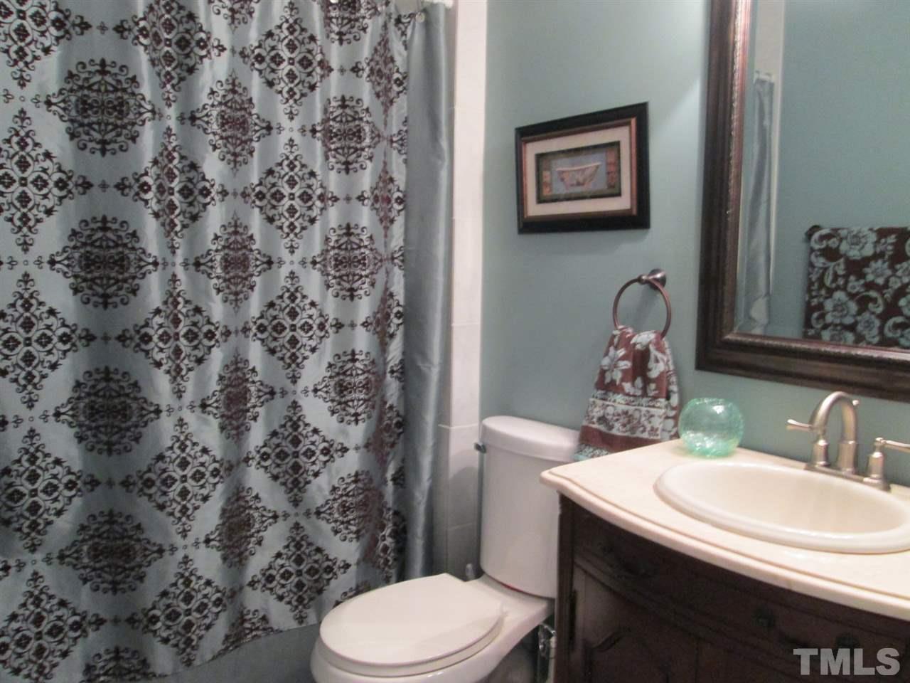 7001 Kiger Road Rougemont, NC 27572 - Photo 17 of 25 a bathroom with a toilet sink and mirror