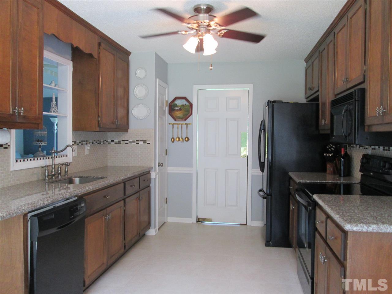 7001 Kiger Road Rougemont, NC 27572 - Photo 8 of 25 a kitchen with stainless steel appliances granite countertop a sink stove and refrigerator