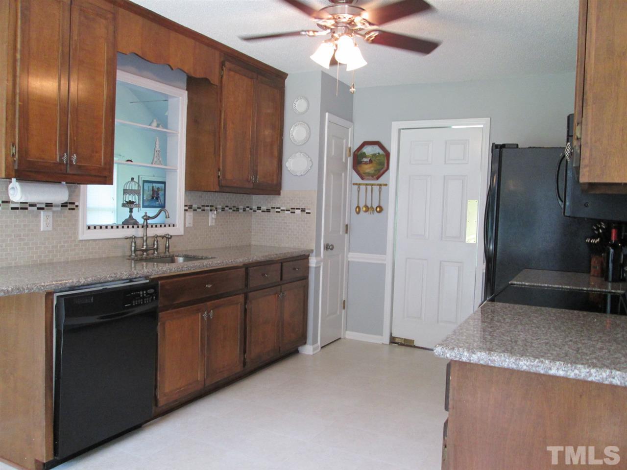 7001 Kiger Road Rougemont, NC 27572 - Photo 9 of 25 a kitchen with granite countertop a sink stainless steel appliances and cabinets