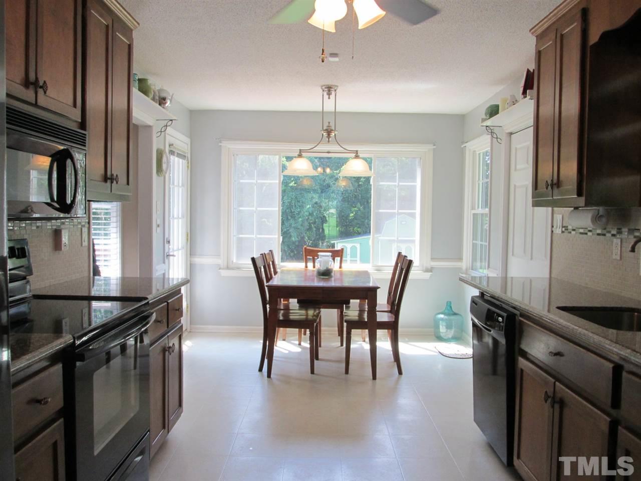 7001 Kiger Road Rougemont, NC 27572 - Photo 10 of 25 a dining room with furniture a window and wooden floor