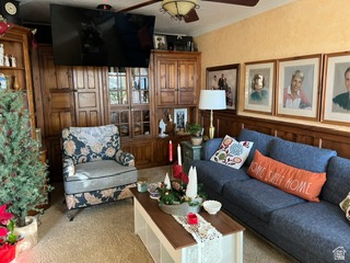 983 Grindelwald Lane, Unit O4 Midway, UT 84049 - Photo 4 of 14 Living space featuring extensive built-in wooden cabinetry, textured wall finish, and a ceiling fan with integrated lighting