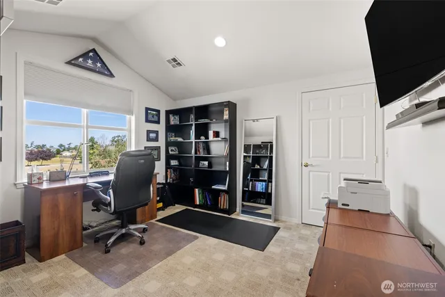 a bedroom with a bed a table and chair