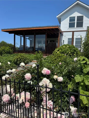 a view of a patio with a dining table and chairs with wooden floor and fence