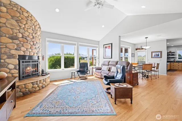 a living room with furniture large window and a table
