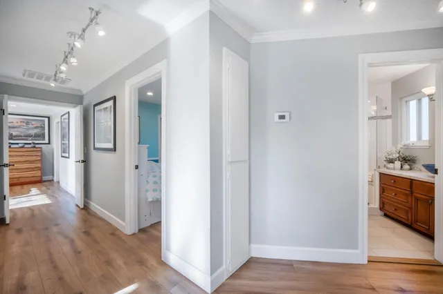 a view of a white house with a swimming pool and sitting area